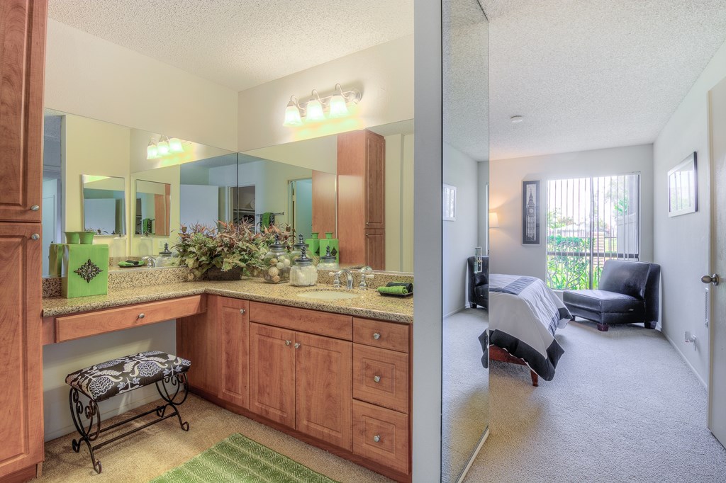A well-lit kitchen with a large island and a dining area with a table and chairs.