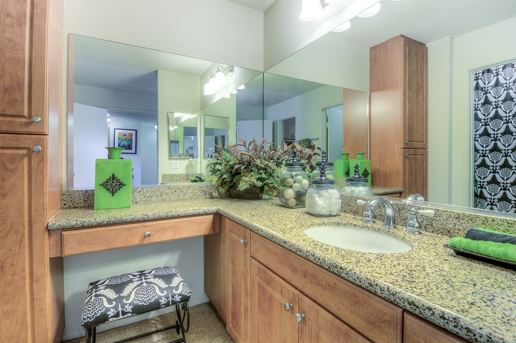 A bathroom with a green bottle on the counter.