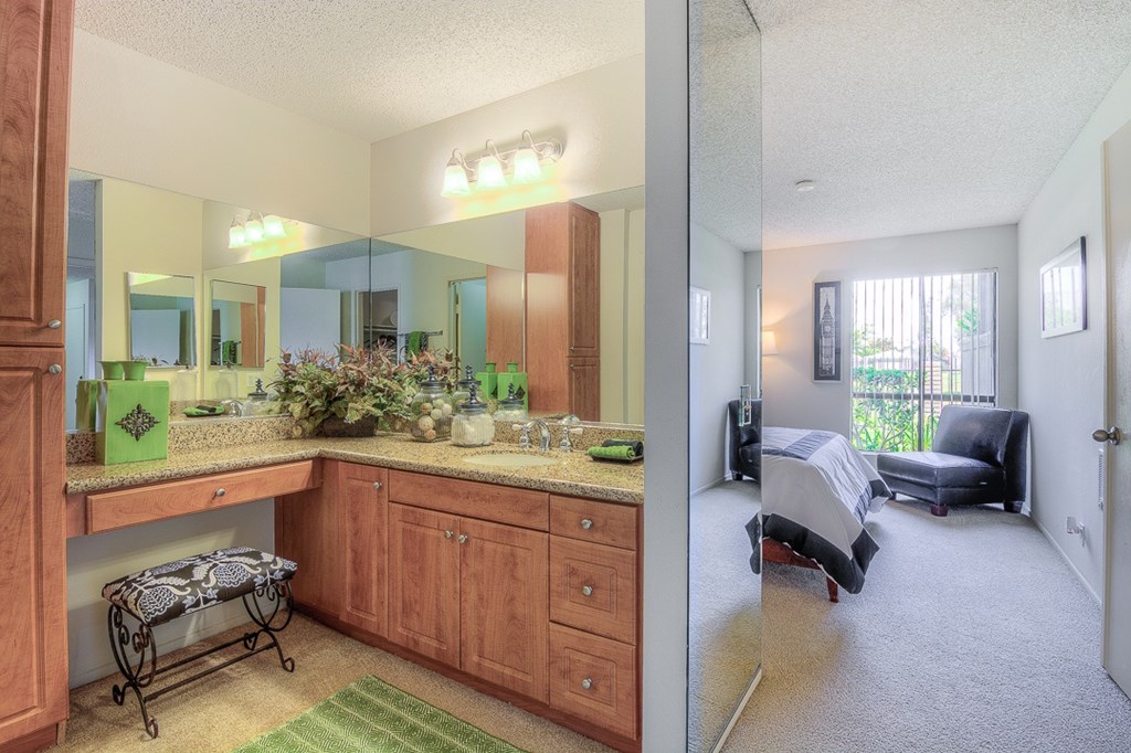 A kitchen with wooden cabinets and a countertop with a green vase on it.
