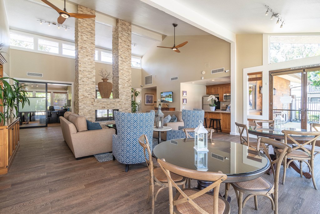 a living room with couches and chairs and a glass table
