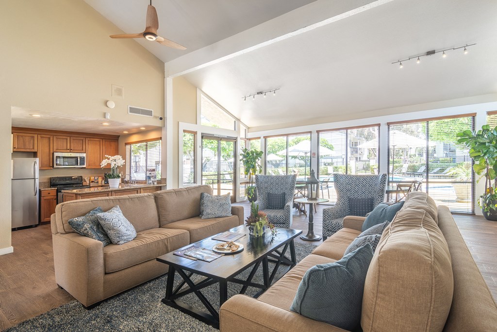 a living room with couches and chairs and a table