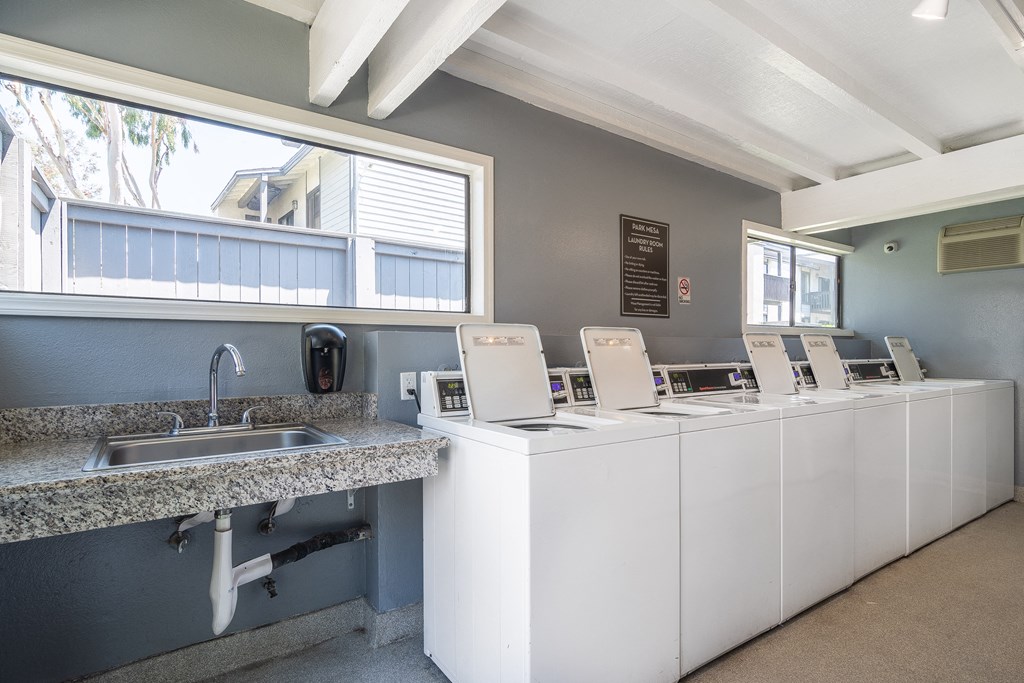 the tasting room is equipped with four sinks and a counter with tasting machines
