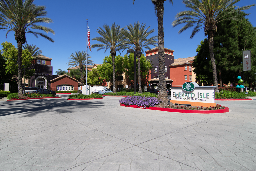 A sign that says Emerald Isle in front of some buildings.
