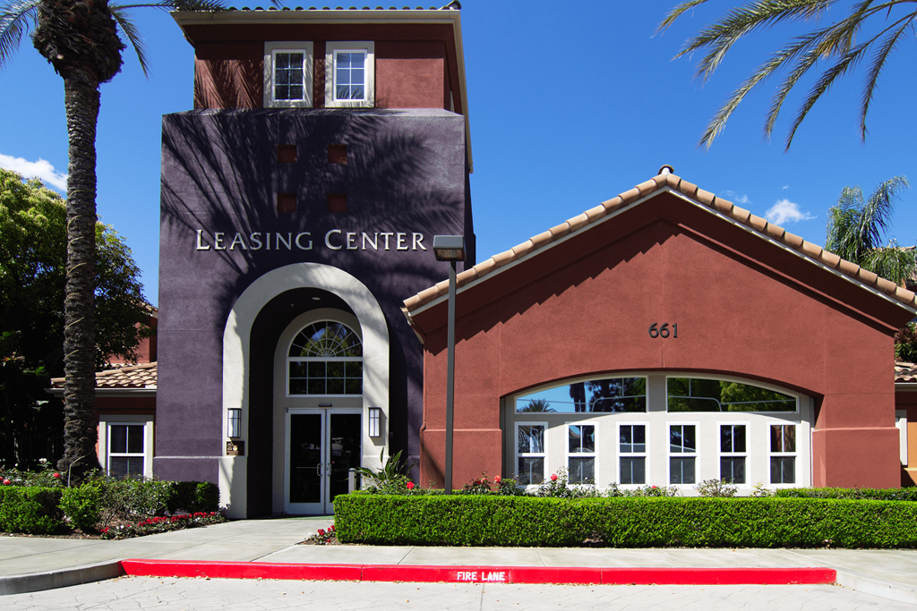 A building with a leasing center sign on it.