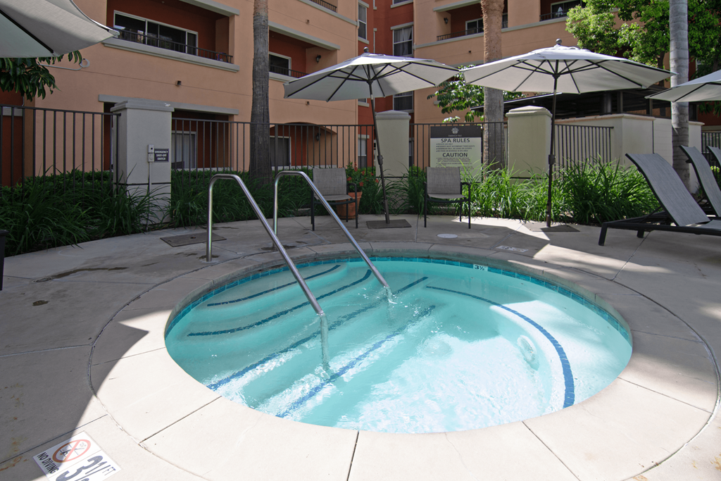A small pool with a fountain in the middle.