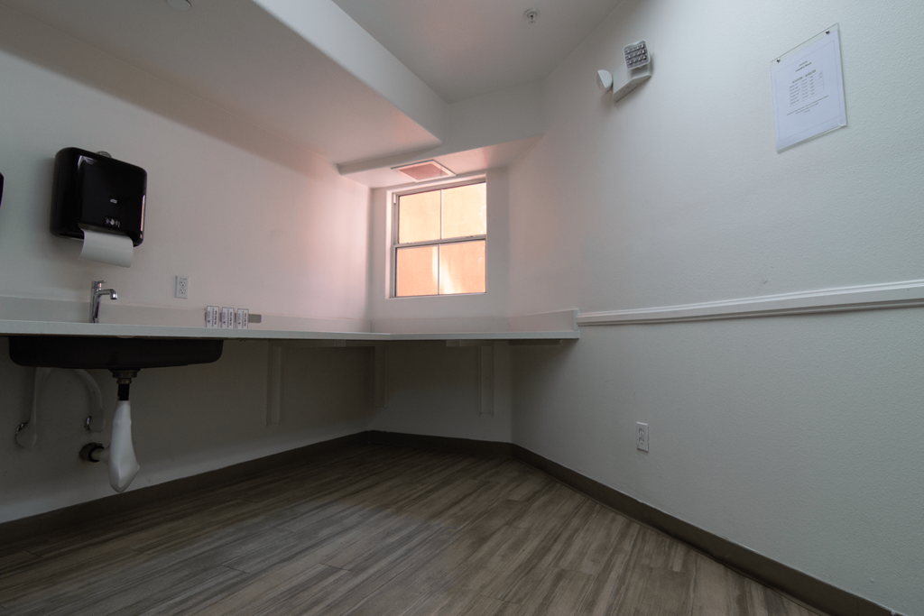 A room with a desk and a window.