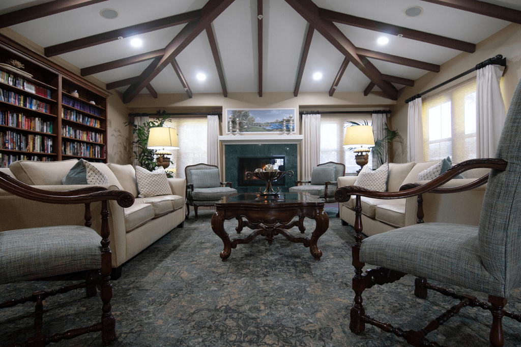 A living room with a fireplace and a bookshelf.