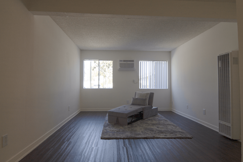 A large bedroom with a bed and a chair.