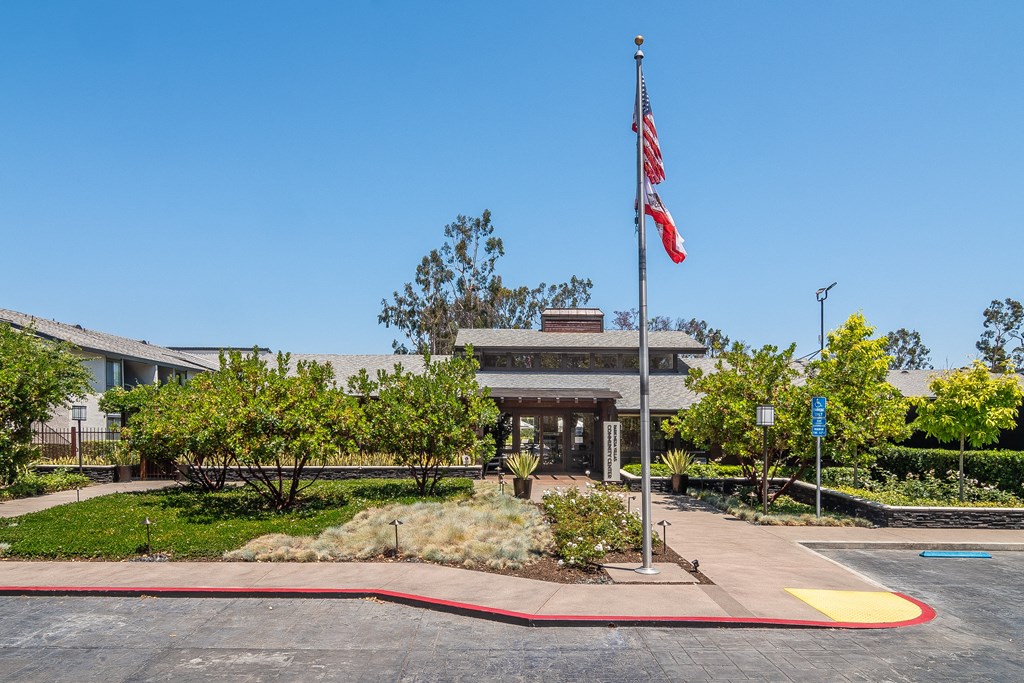a flagpole with an flag in front of a building
