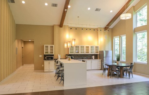a large kitchen with a dining area and a table