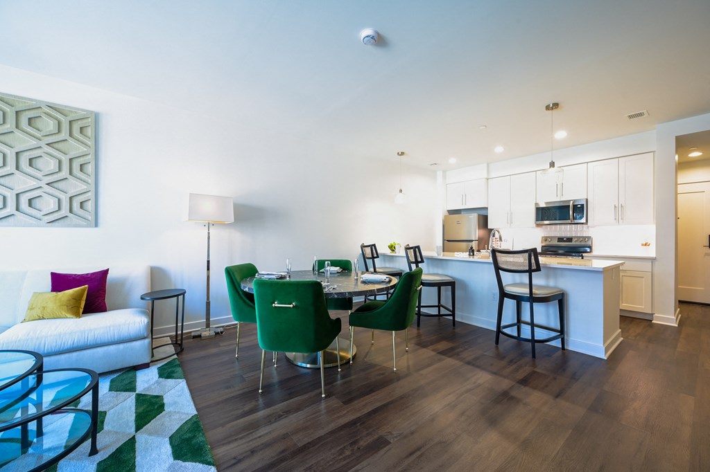 a living room and dining room with a table and chairs at Ingram Manor, Pikesville, MD