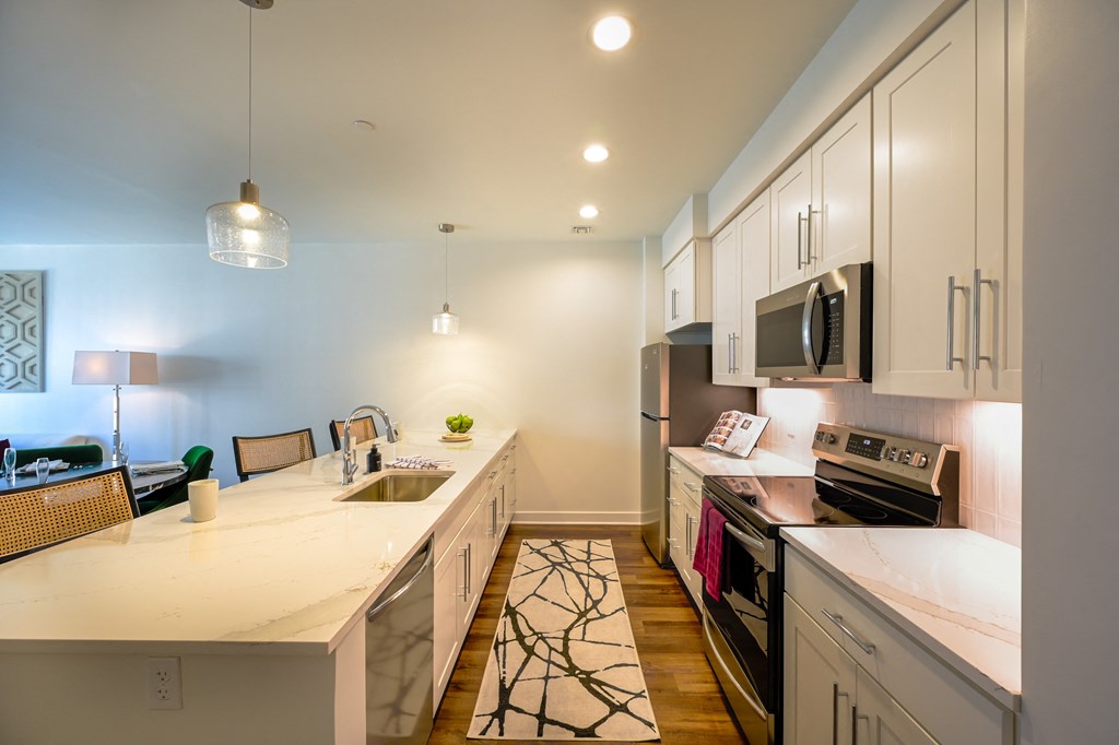 a kitchen with white cabinets and a white counter top at Ingram Manor, Pikesville, MD