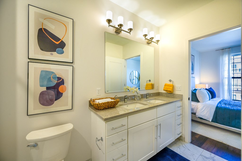 a bathroom with a toilet and a sink and a mirror at Ingram Manor, Pikesville, MD