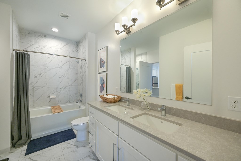 a bathroom with a sink and a shower and a toilet at Ingram Manor, Pikesville, MD