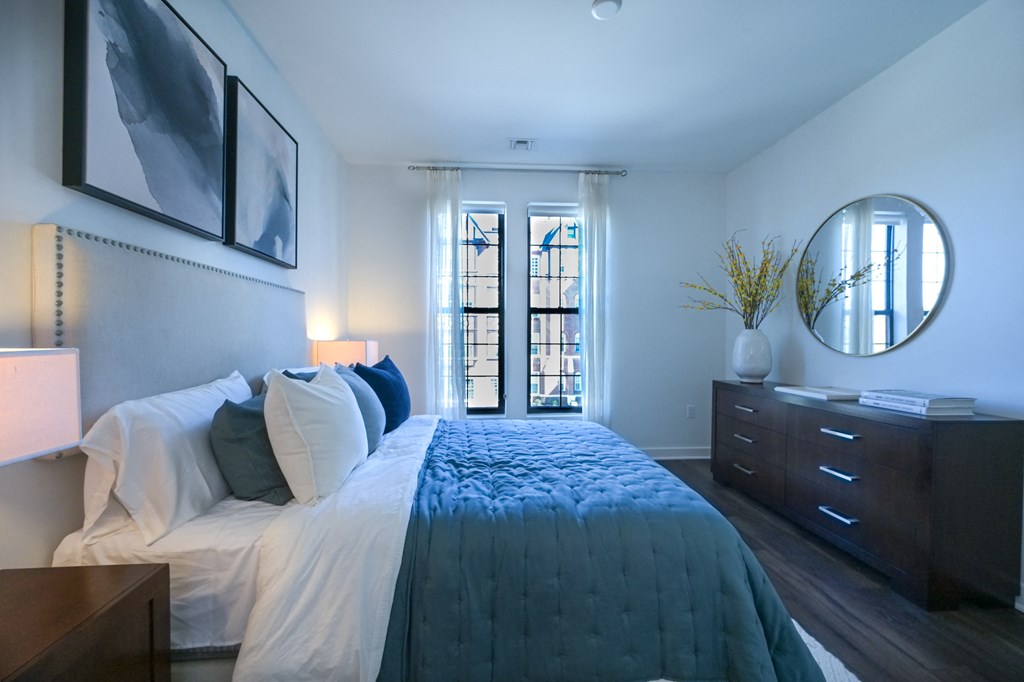 a bedroom with a large bed and a mirror on the wall at Ingram Manor, Pikesville, MD