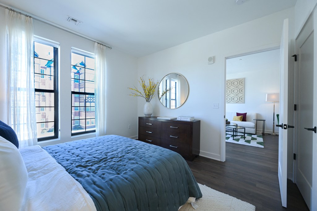 a bedroom with a bed and a dresser and a large window at Ingram Manor, Pikesville, MD