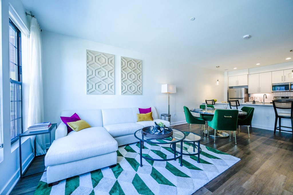 a living room with a white couch and a glass coffee table at Ingram Manor, Pikesville, MD