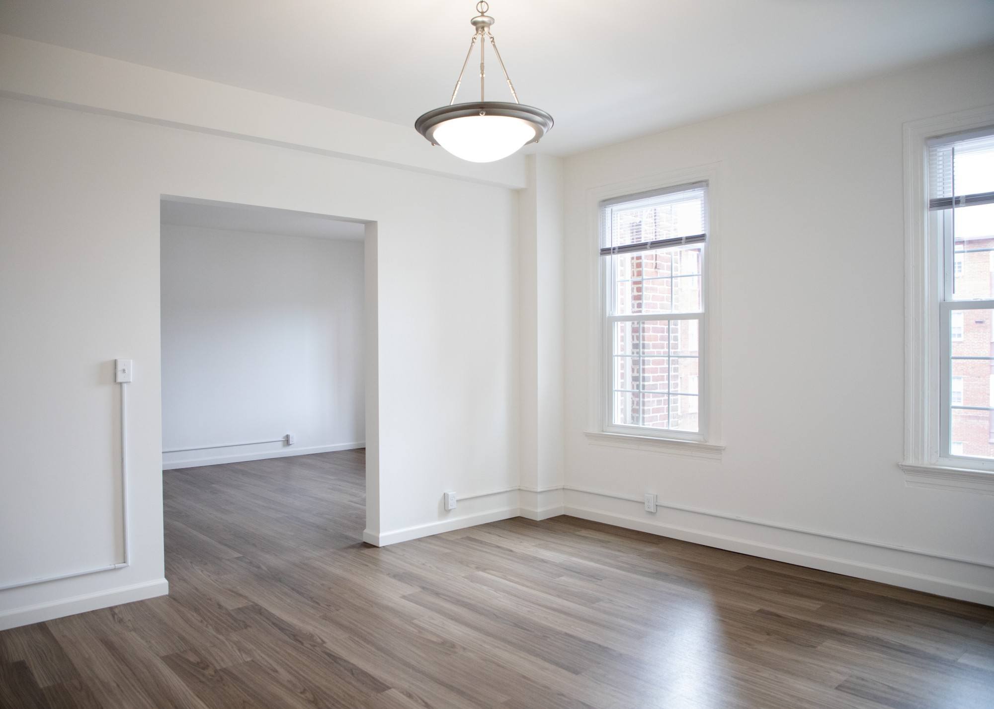 A room with a wooden floor and a window.