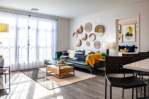 A modern living room with a green couch and a coffee table.