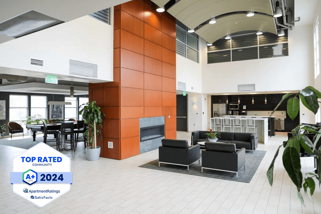 Metro Crossing Apartments Clubhouse  Interior with Resident Satisfaction Logo Banner