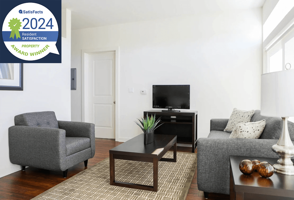Metro Crossing Apartments Living Room Interior with Resident Satisfaction Logo Banner