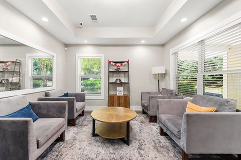 A living room with grey couches and a wooden coffee table.