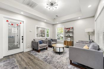 A living room with a grey couch and a coffee table.at Bradford Gwinnett Apartments and Townhomes, Norcross Georgia