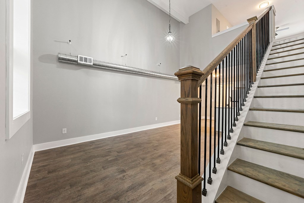 The landing of a staircase and living room at Crogman School Lofts, Atlanta, 30315