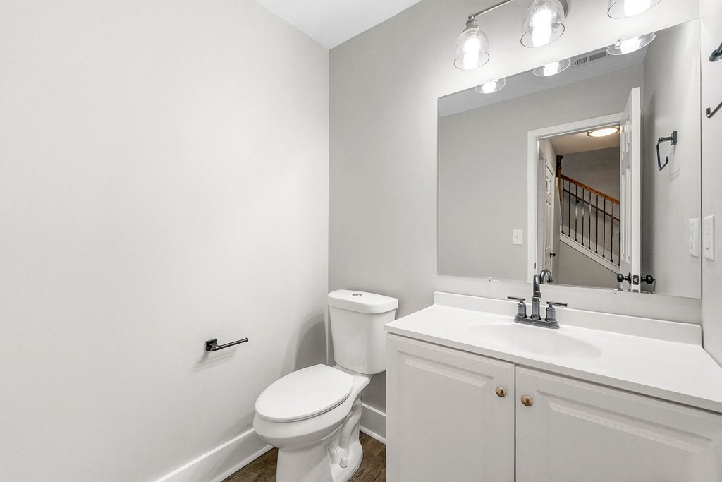 Bathroom/ powder room with a sink toilet and a mirror at Crogman School Lofts, Atlanta, 30315