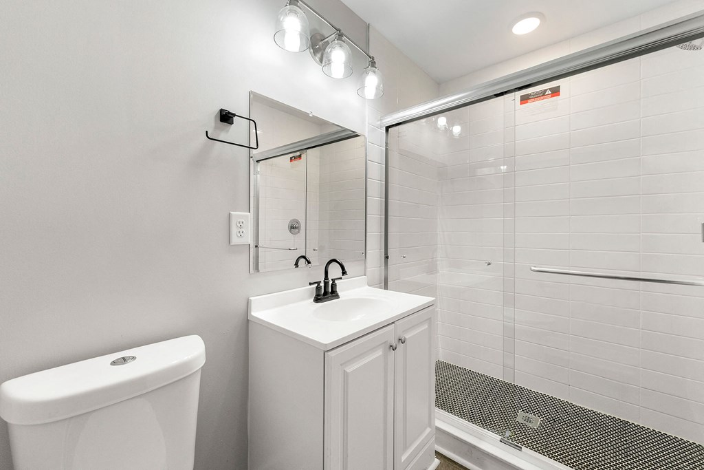 Bathroom with a sink toilet and a shower at Crogman School Lofts, Atlanta, 30315
