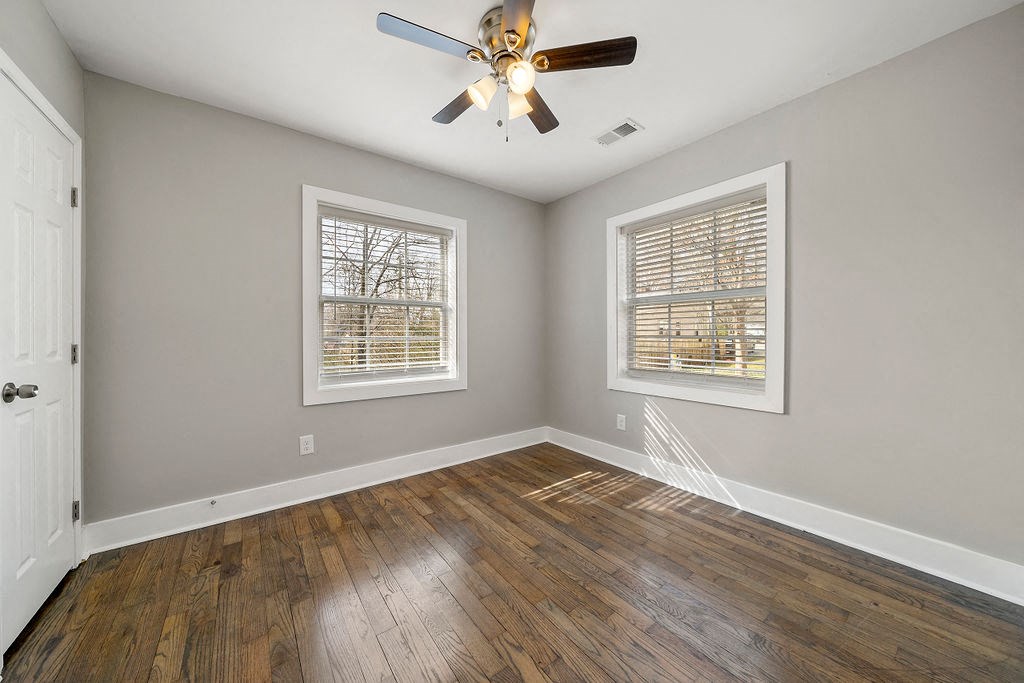 A bedroom with a bed, a ceiling fan and window at Balfour Marietta Apartments, Marietta, GA