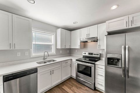 a kitchen with white cabinets and stainless steel appliances  at 1760 Memorial, Atlanta, 30317