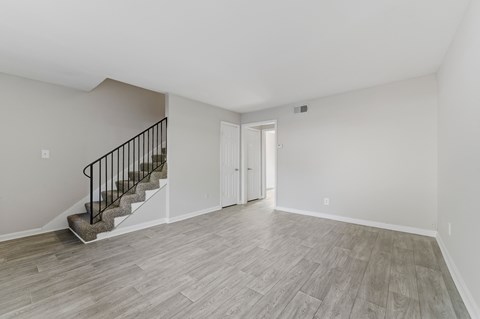 A room with a staircase and a door.