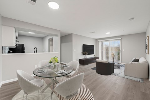 A modern living room with a glass table and white chairs.