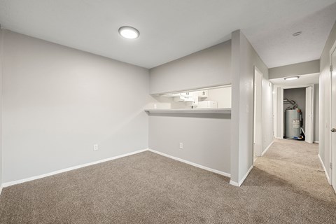 A room with a carpeted floor and a white ceiling with a light fixture.