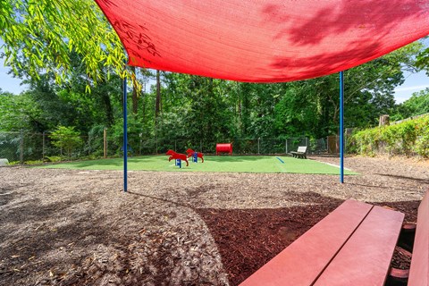 Shaded seating area within the pet play area at Georgian Oaks Apartments, Smyrna , GA