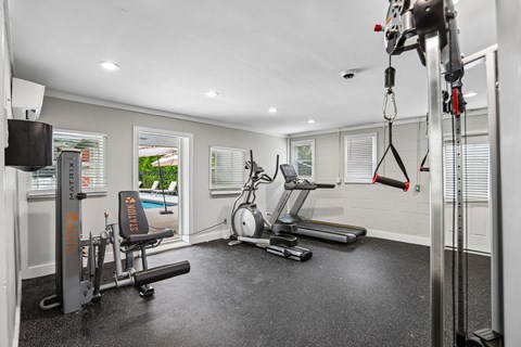 A well-equipped home gym with a variety of exercise machines.