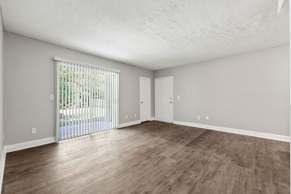 Spacious living room with new flooring at Pines at Lawrenceville Decatur 30033