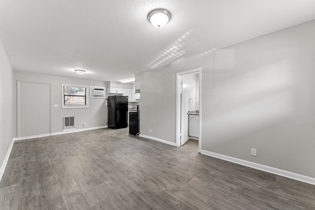 a living room with hardwood floors and grey walls  at Balfour 296, Lilburn, GA