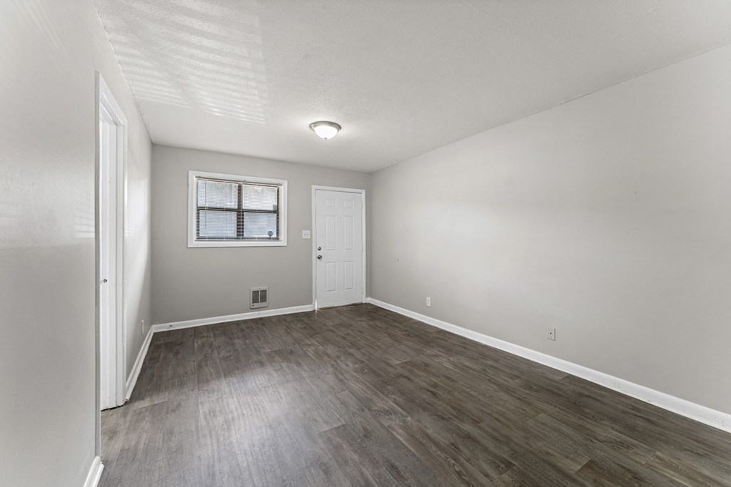 a bedroom with hardwood floors and grey walls  at Balfour 296, Lilburn, Georgia