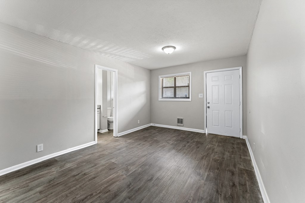 a bedroom with hardwood floors and grey walls  at Balfour 296, Georgia, 30047