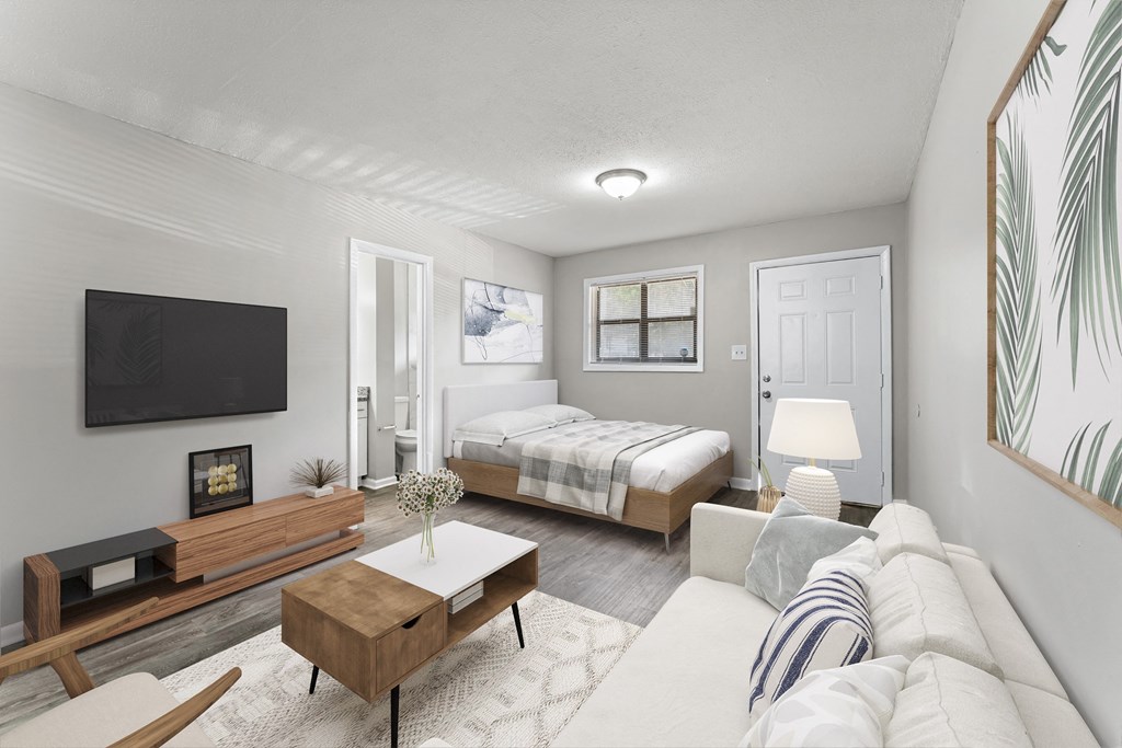 a bedroom with a bed and a tv in a room  at Balfour 296, Lilburn