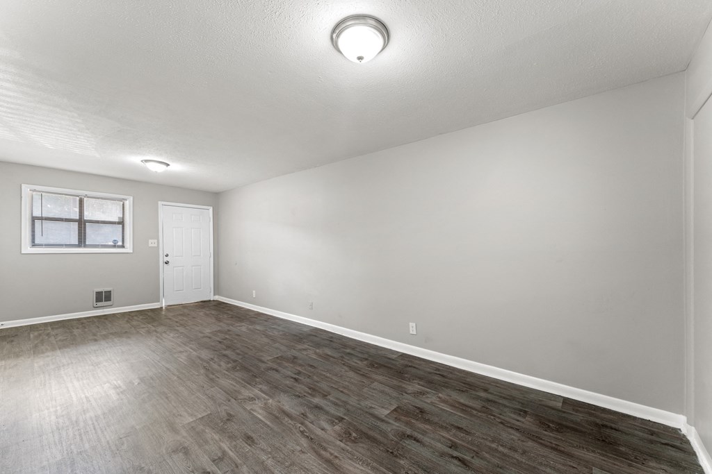 a bedroom with hardwood floors and grey walls  at Balfour 296, Lilburn, GA