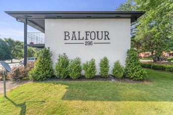 a building with a lawn and trees in front of it  at Balfour 296, Lilburn, GA
