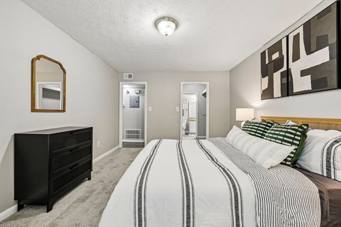 A bedroom with two beds and a dresser.