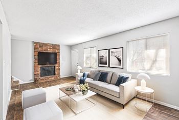 a living room with a couch and a fireplace at Northgate Townhomes in Tucker, Georgia