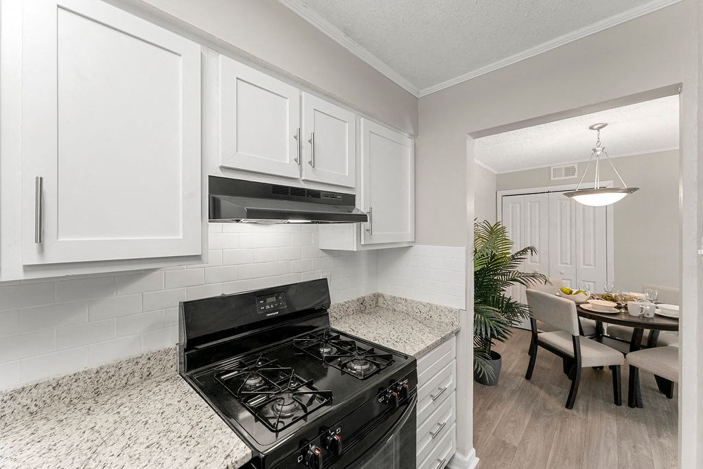 Updated kitchen granite countertops soft-close cabinetry black appliances at 445 Cleveland, Atlanta, GA 30354