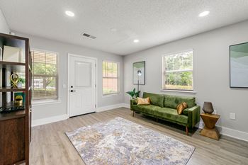 a living room with a green couch and a rug at 445 Cleveland, Atlanta ,Georgia 30354