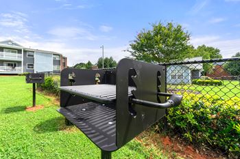 a bench in a park next to a chain link fence at 445 Cleveland, Georgia