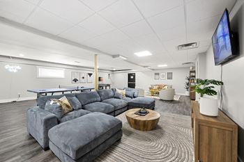 clubhouse with large blue couch and TV at Gardens at Washington Park, Atlanta, Georgia
